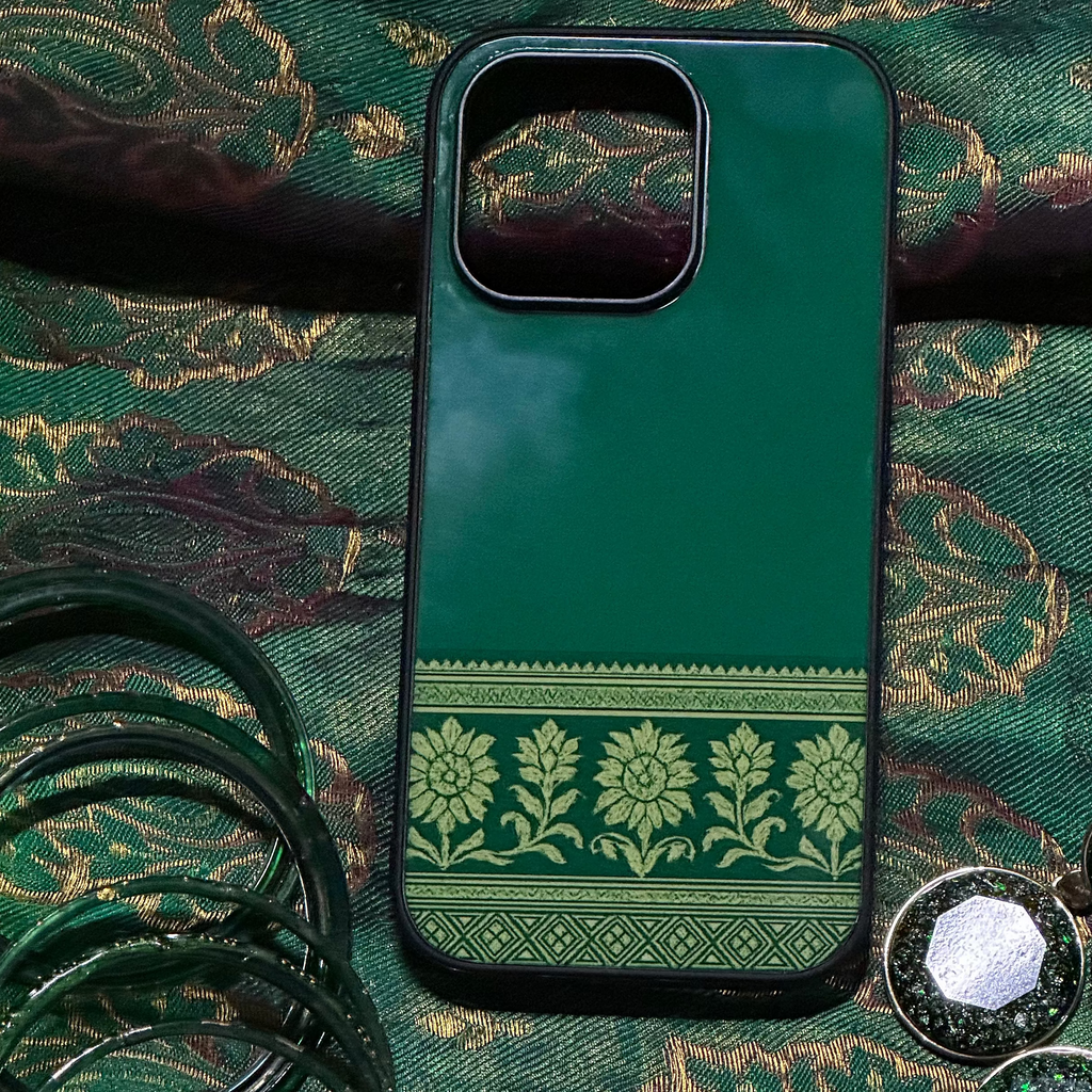 Green phone case with decorative pattern on a green fabric background