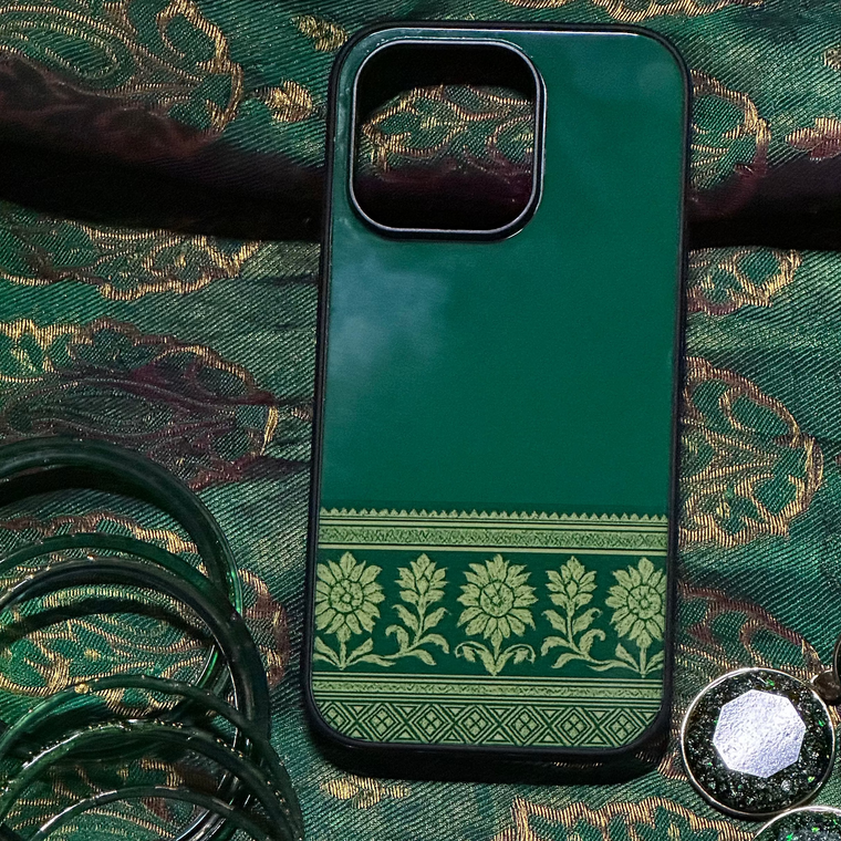 Green phone case with decorative pattern on a green fabric background