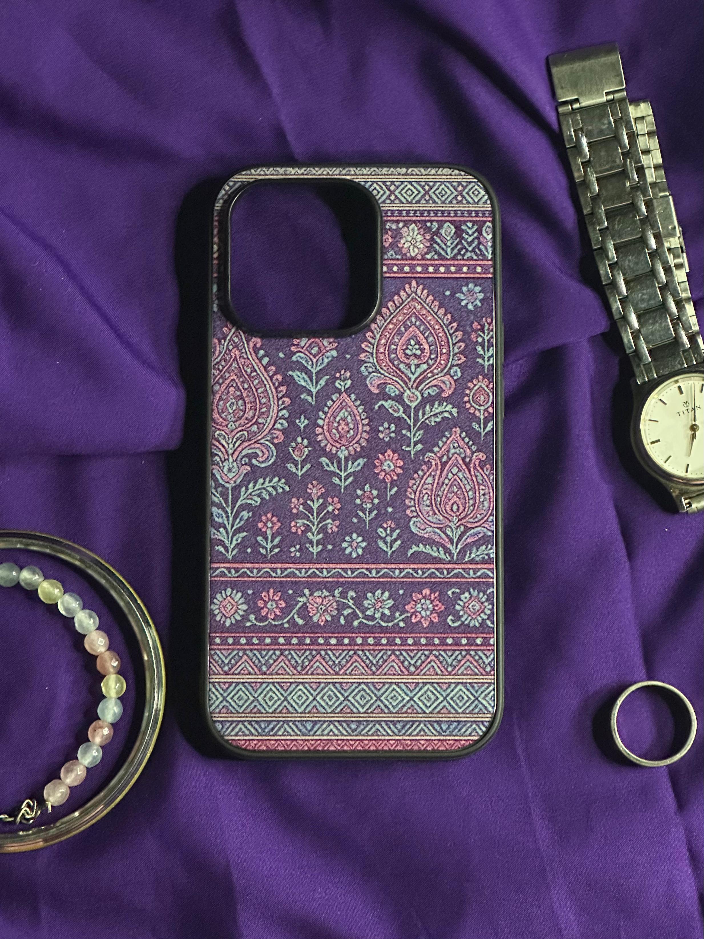Phone case with paisley pattern on a purple fabric background
