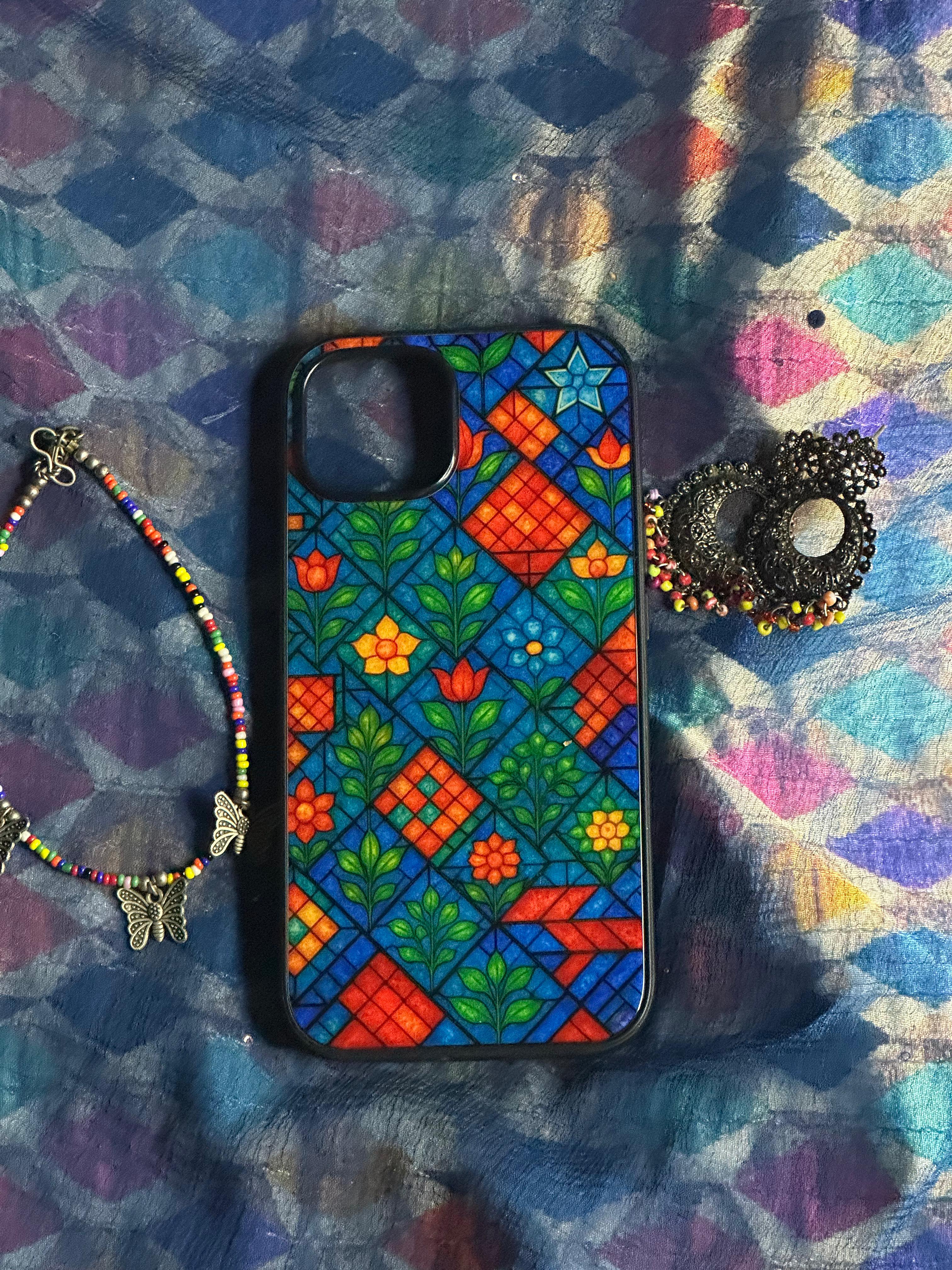 Colorful patterned phone case on a textured fabric background