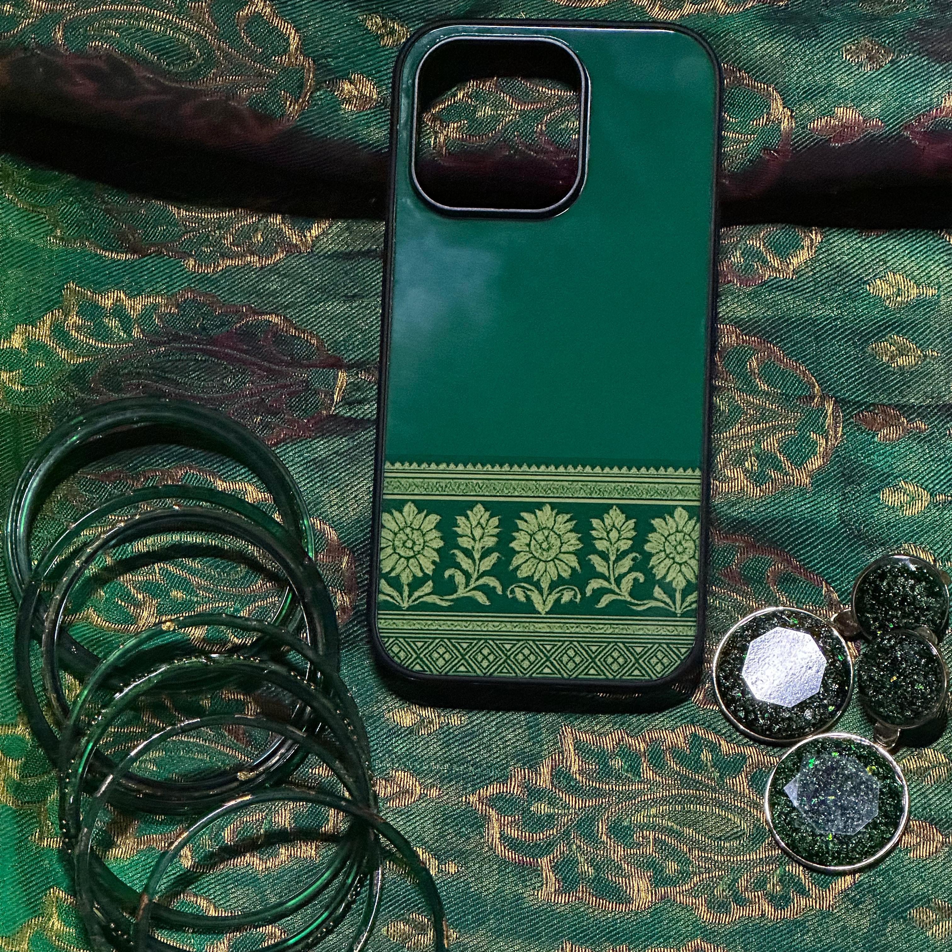 Green phone case with floral pattern on a green fabric background